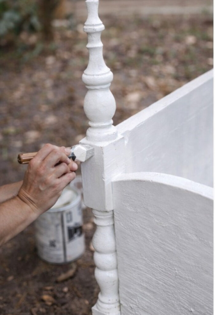 Painting a DIY porch swing bench made out of a bed frame.  