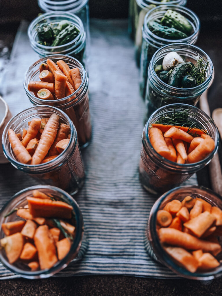 Jars of pickled carrots ready to be sealed and canned.