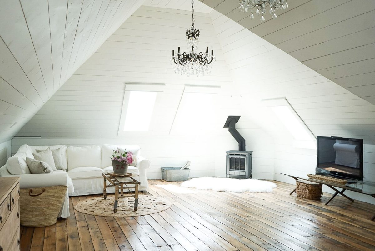 Shiplap Attic with Farmhouse Chandelier white couch fireplace family room