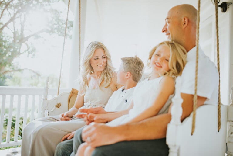 a family together on a porch after setting personal goals and family goals