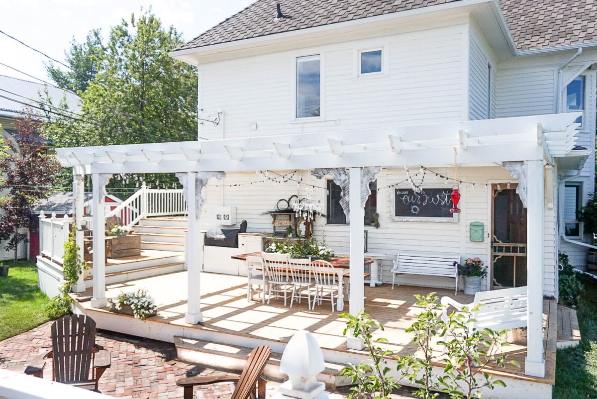 large pergola on a wrap around deck
