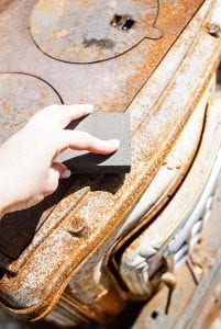 sanding the outdoor wood burning fireplace