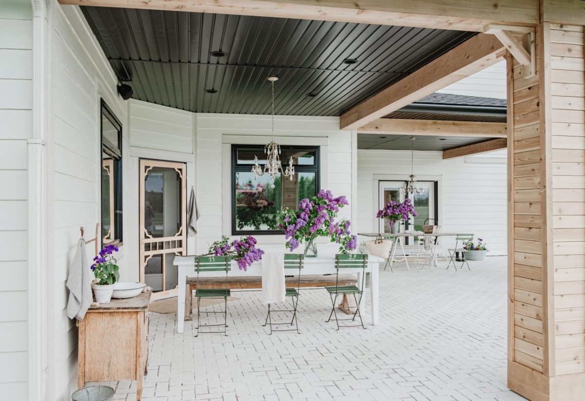 DIY Chandelier A beautiful patio with a farmhouse table with lilacs and washstand.