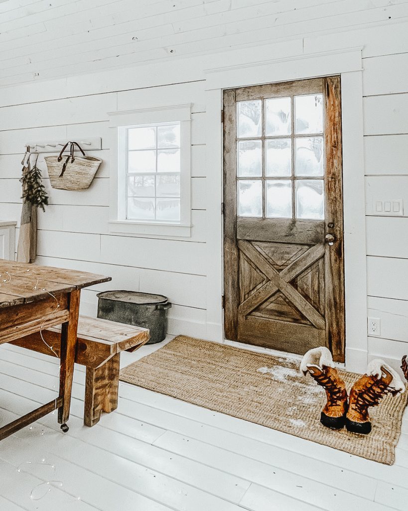 cabin with a salvaged front door and painted floors