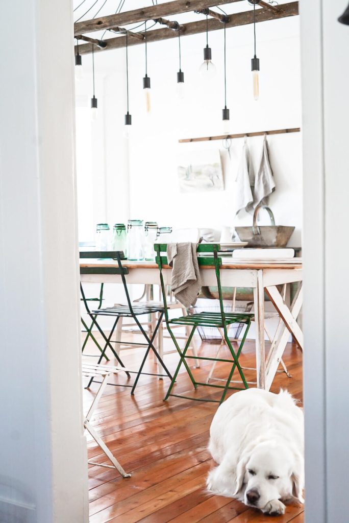 view of a simple dining room with a farmhouse table and decor