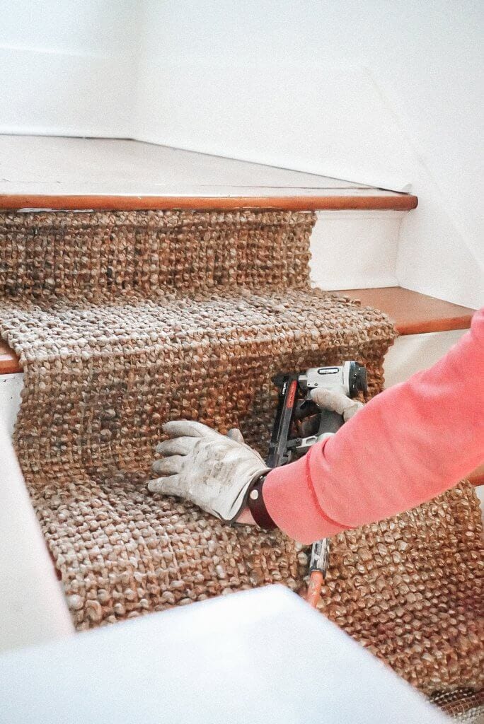 installing a diy stair runner made of jute with a pneumatic staple gun