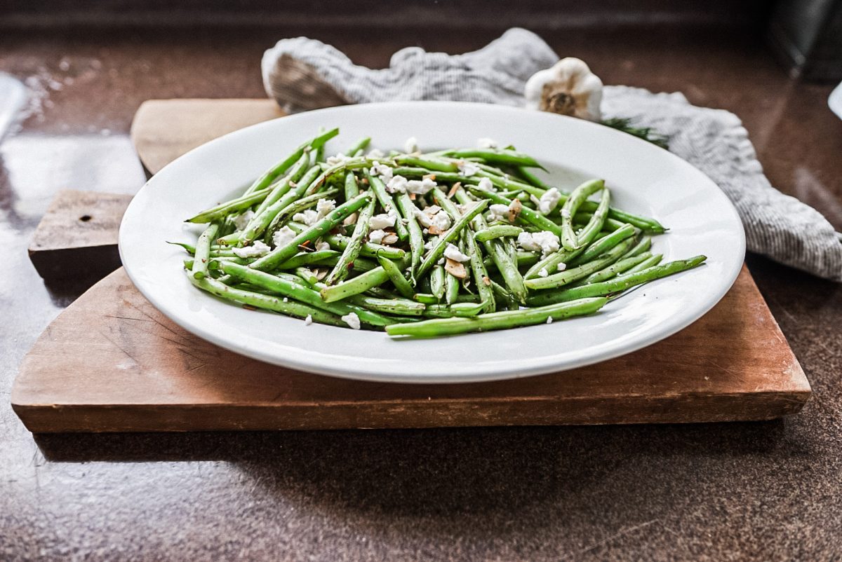 Green Bean Salad Green Bean salad with goat cheese on a platter and cutting board.