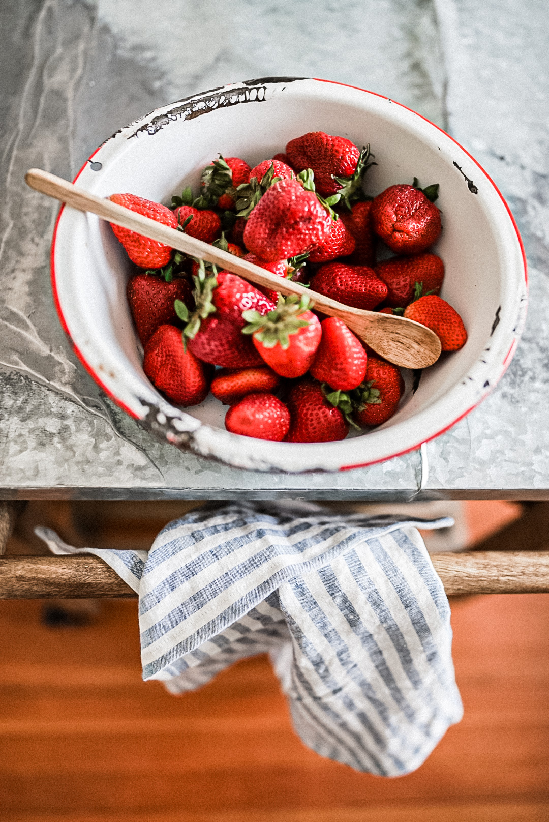 bowl of strawberries with wooden spoon bowl of strawberries with wooden spoon