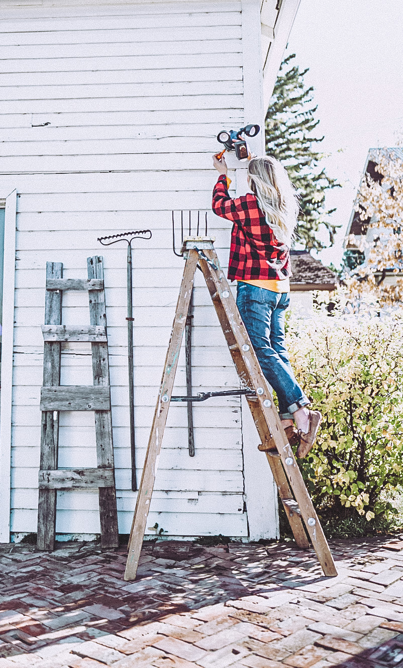 Girl installing outdoor lighting