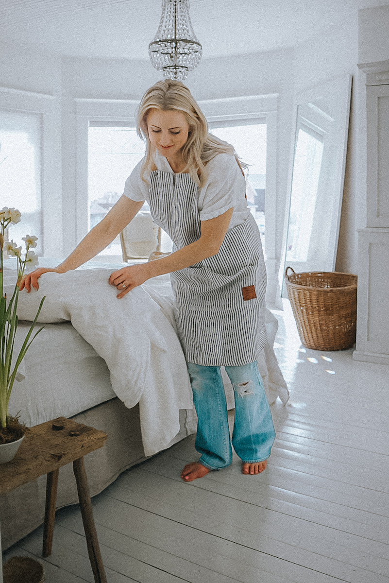 linen-sheets girl making a bed with linen sheets