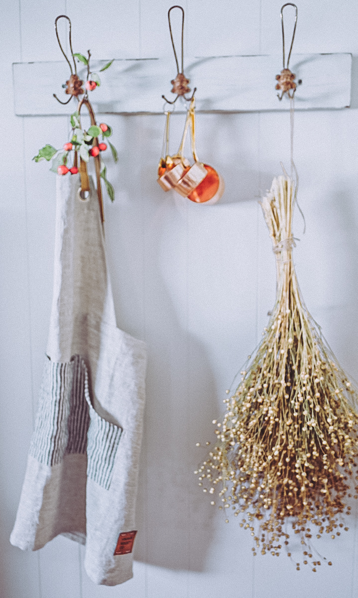linen apron-12 linen apron hung on a hook beside fall foliage