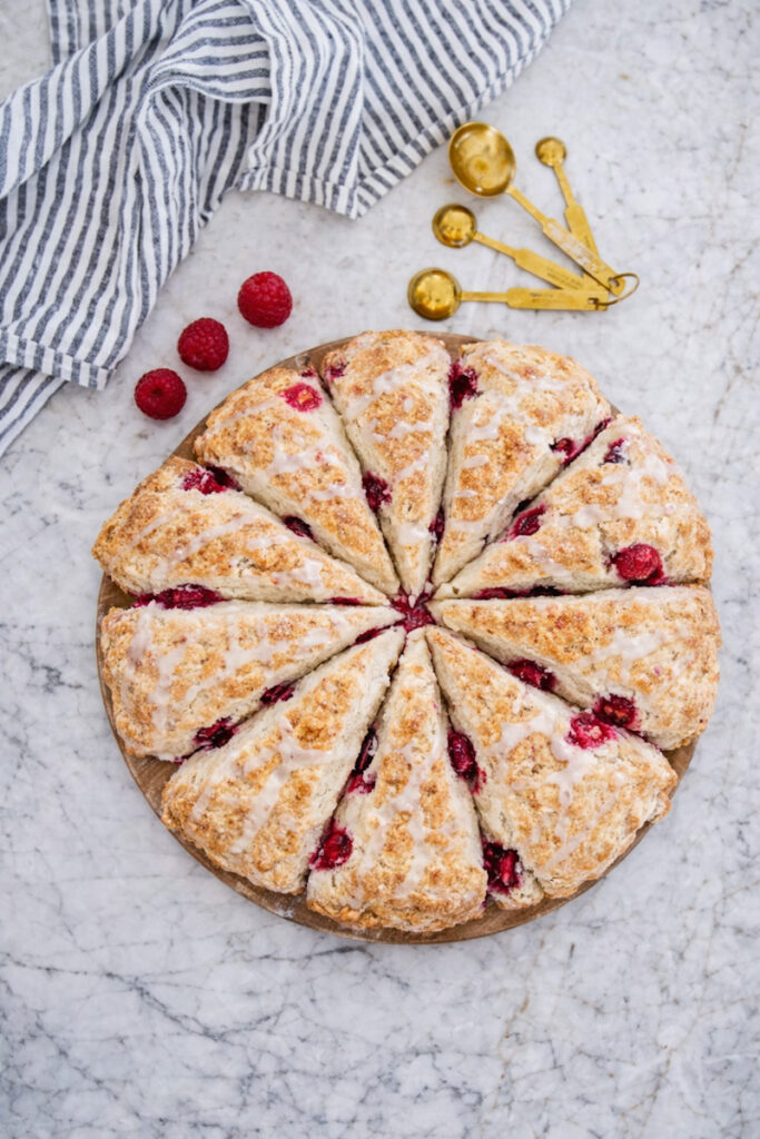 Delicious white chocolate raspberry scone on a marble countertop. 