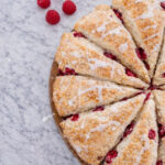 White chocolate raspberry scone with a vanilla glaze drizzled on top