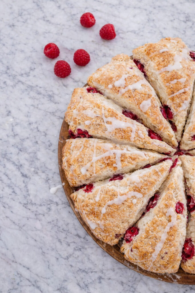 Freshly baked raspberry scones with vanilla drizzle on top. 