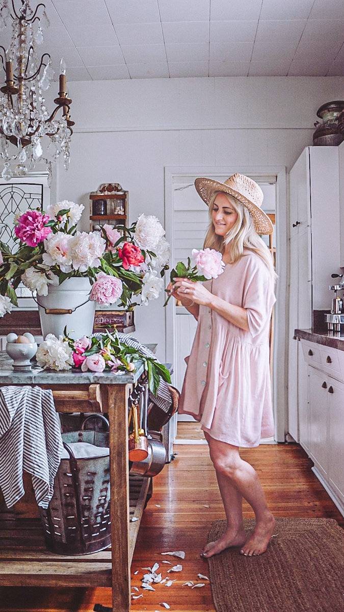 making homemade flower food in a kitchen with a bucket of peonies