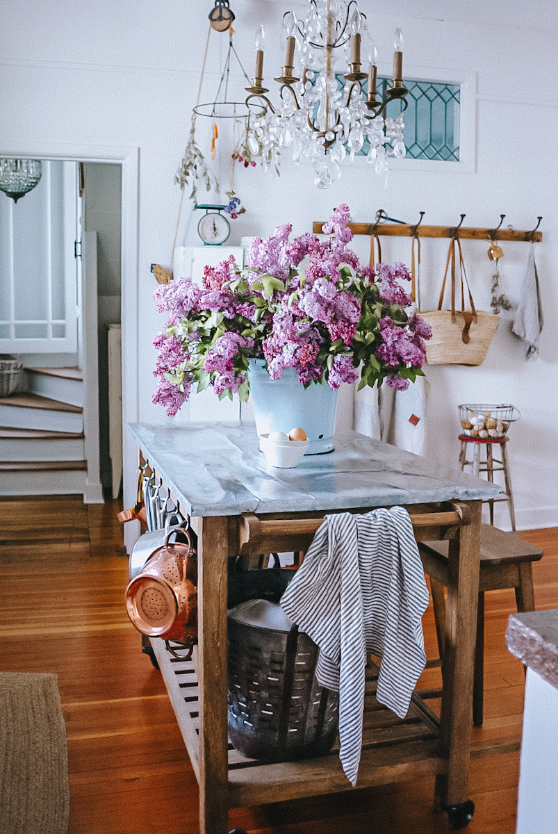 Large bucket of lilacs in a farmhouse kitchen