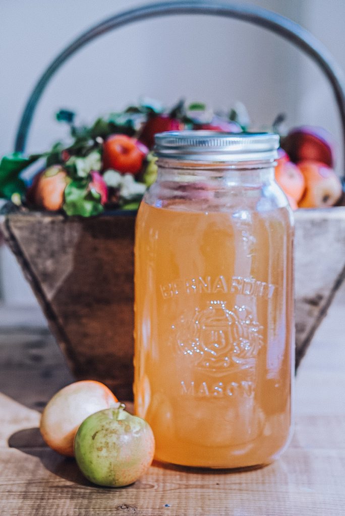 Homemade apple juice in a large mason jar