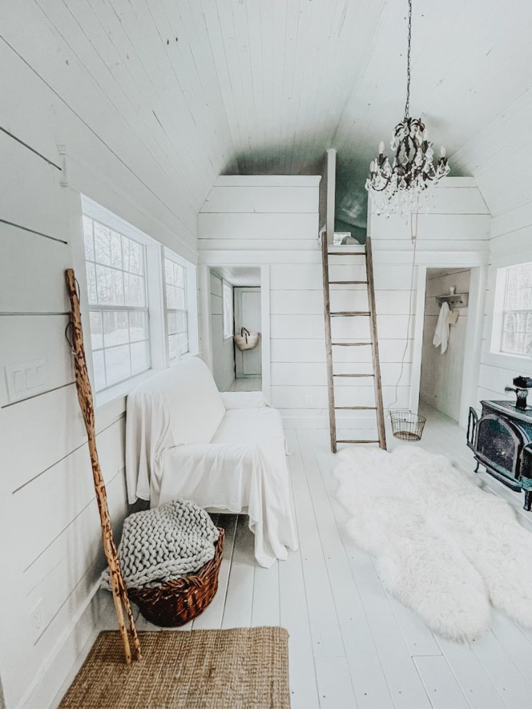 simple winter decor with birch poles, chunky blankets and wicker baskets in a family room