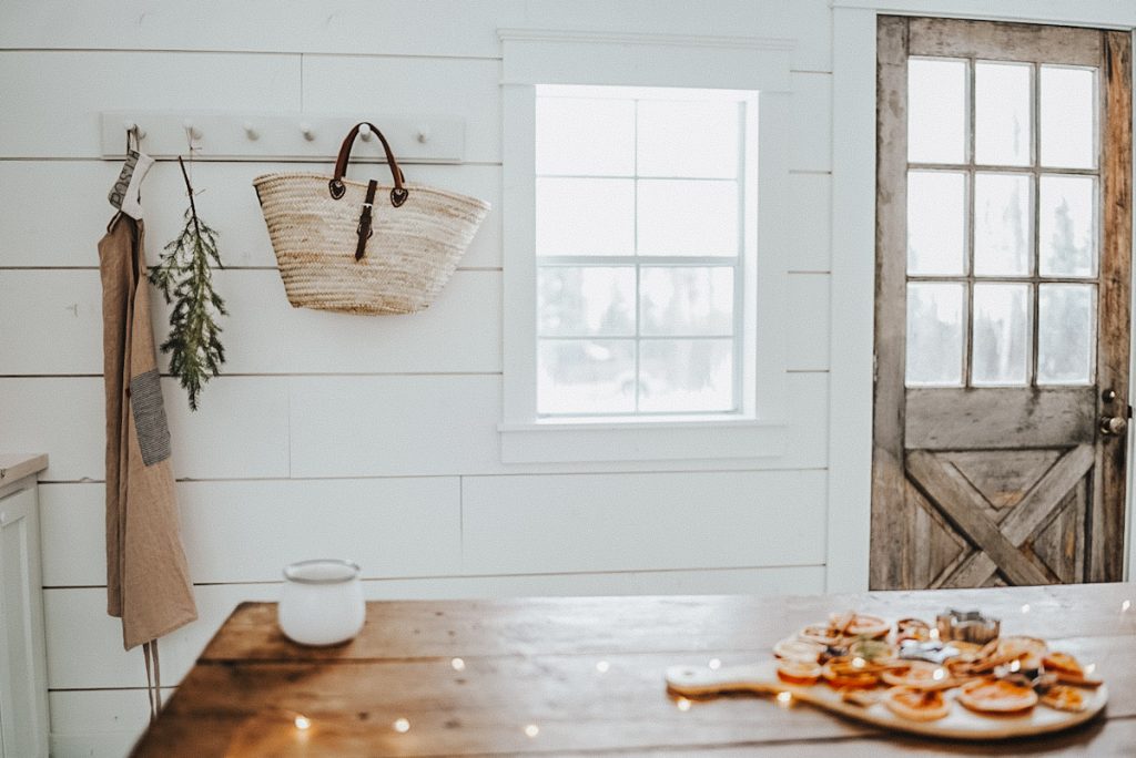 Scandinavian winter decor of evergreen branches and twinkle lights in a cabin