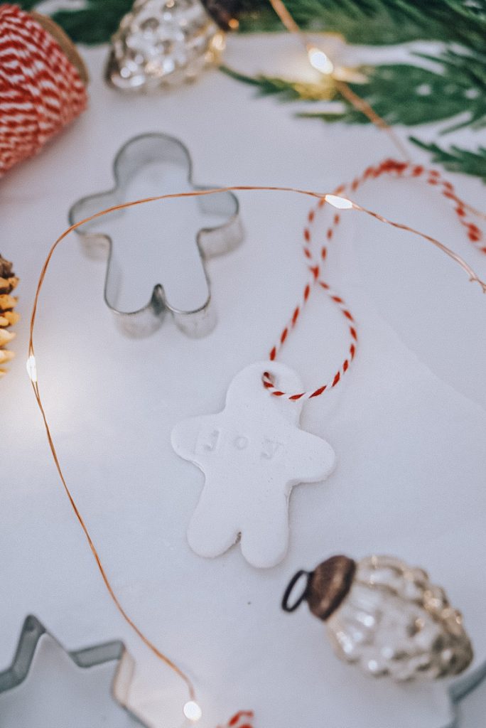 gingerbread man DIY air dried clay Christmas ornament completed with a red twine string