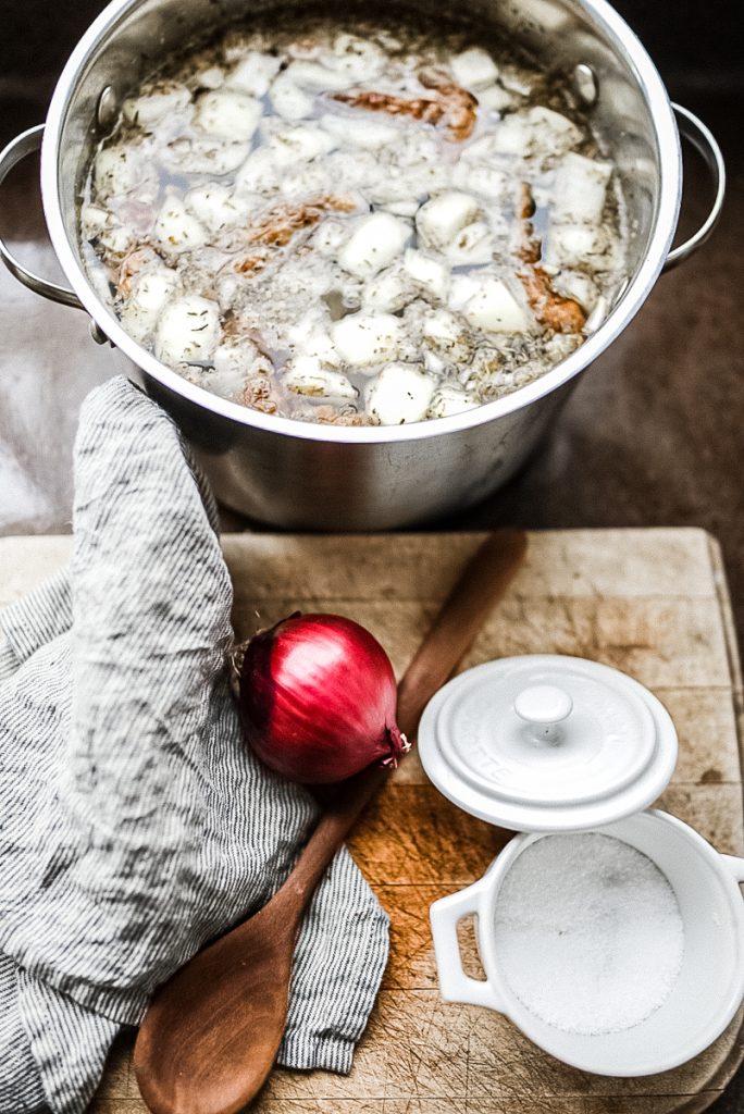chicken broth in a pot with onions