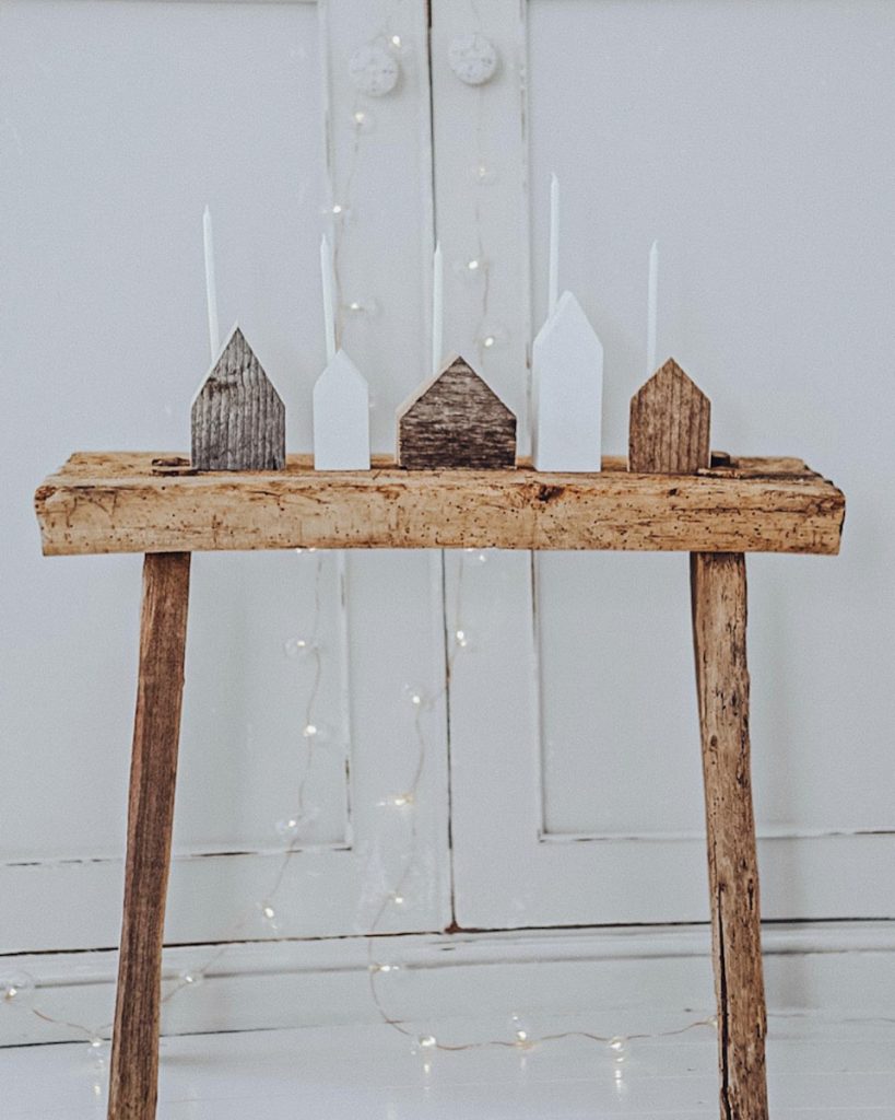 tiny handmade wood village with candles for