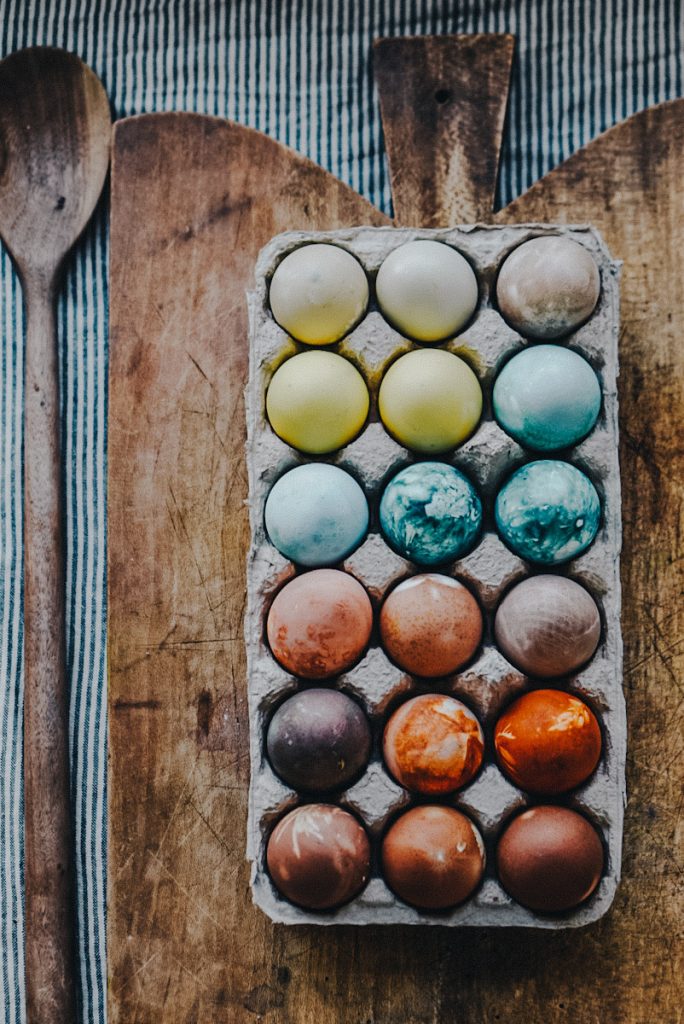 blue, yellow, orange and purple eggs dyed with natural egg dye