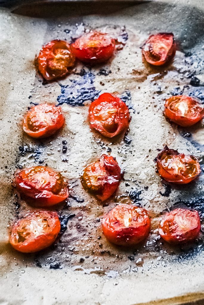 fire-smoked tomatoes on a parchament lined stone baking tray