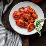 fire roasted tomatoes on a plate with basil