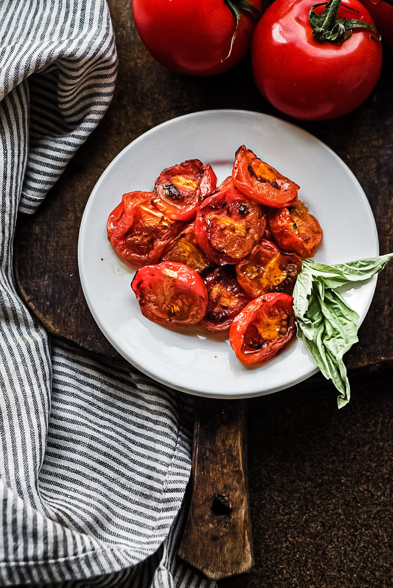 fire roasted tomatoes on a plate with basil