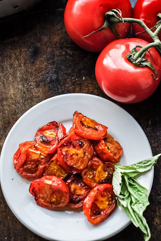 Fire smoked tomatoes on a plate to be eaten.