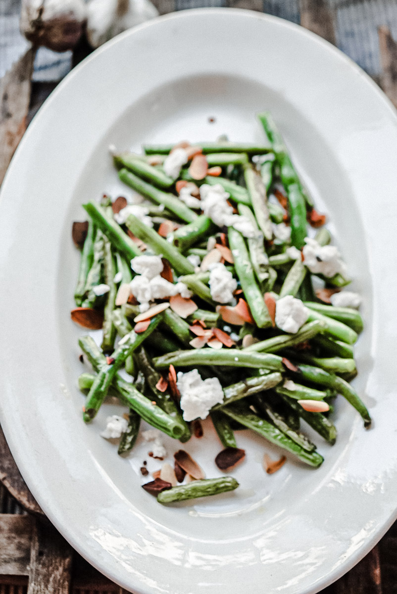 a delicious plate of green bean salad on a french ironstone platter