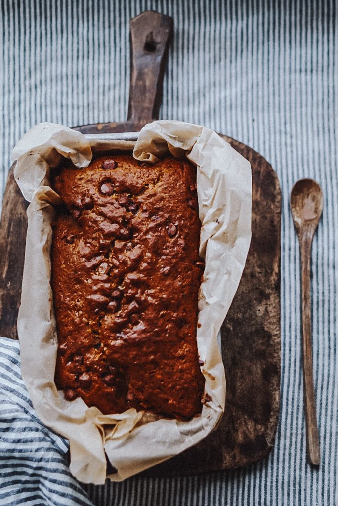 No butter banana bread with oil in a bread loaf pan with parchment paper