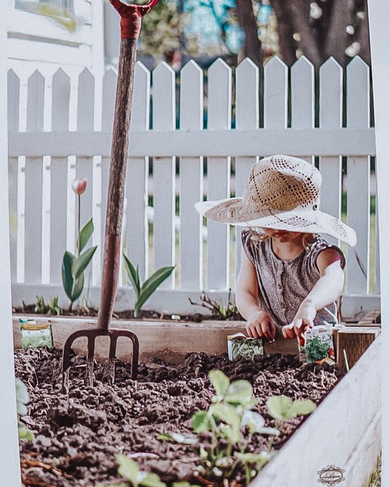 little girl planting seeds in the garden