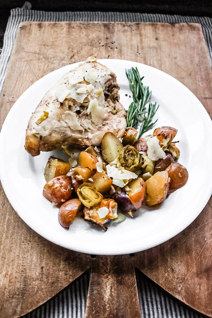 braised chicken and leeks with rosemary potatoes on an ironstone plate