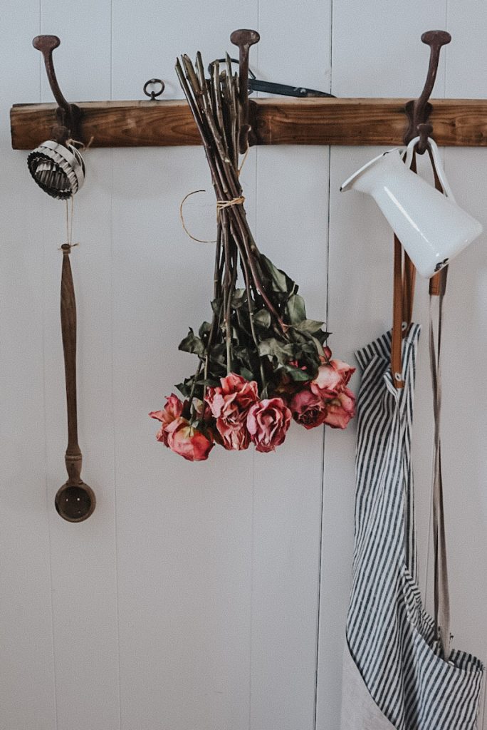 air drying roses on a hook in a kitchen
