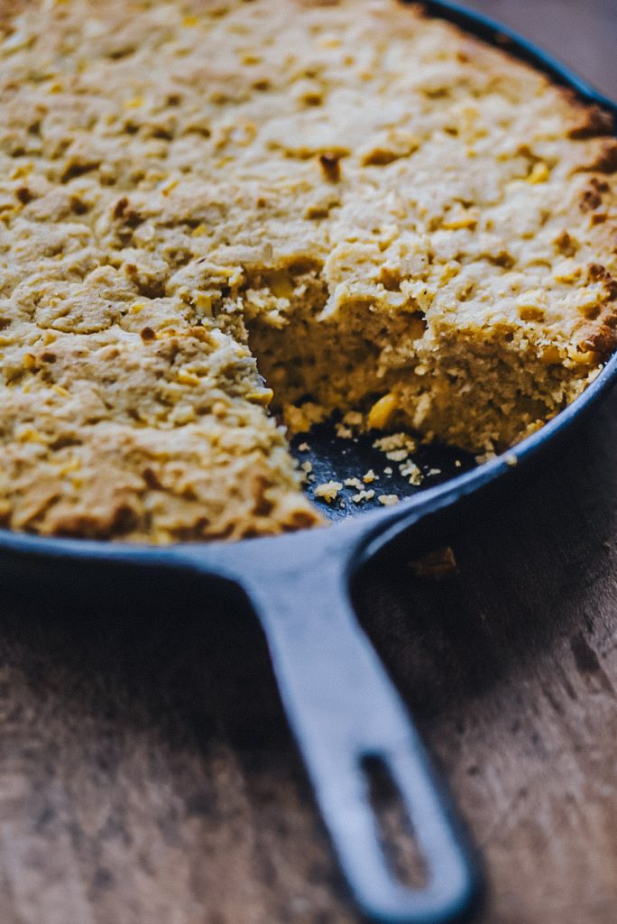 Cast iron skillet with cornbread in it.