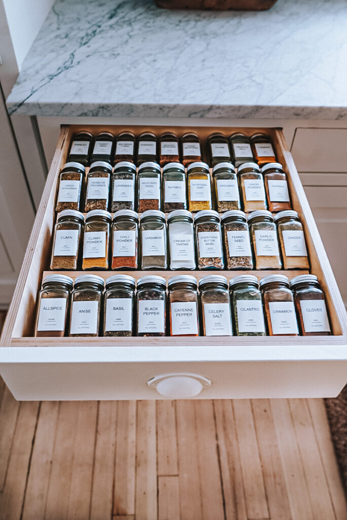 Spice drawer completely organized alphabetically using jars and custom labels. 