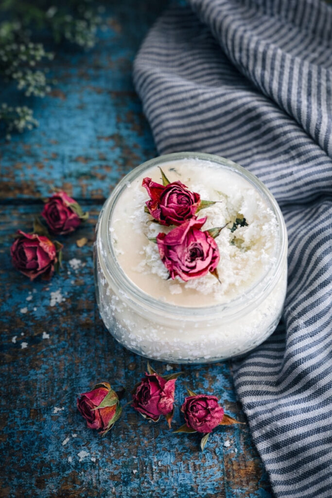 Tallow moisturizer with dried roses on top.