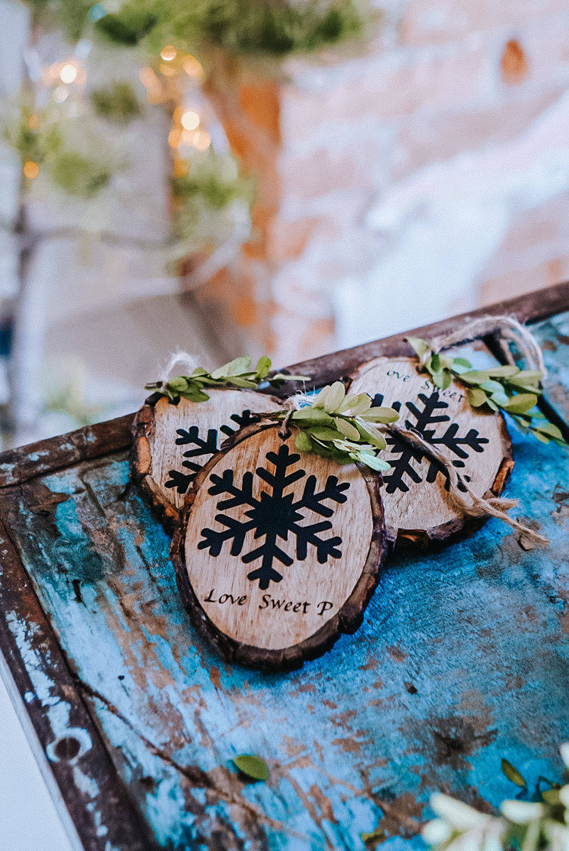 Beautiful DIY wood slice ornaments with a snowflake on them, made using a Cricut vinyl design.