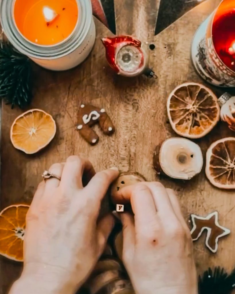 Stamping wooden ornaments for Christmas with letter stamps.