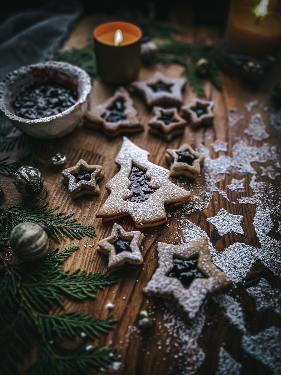 Jam filled Linzer tart cookies in different shapes for Christmas