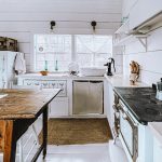 Beautiful white tiny house minimal kitchen that is very clutter free and organized.