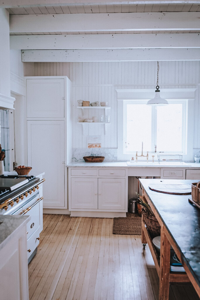Beautiful Scandinavian-style white kitchen with clear counters and minimalist features.