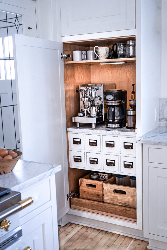 Coffee station with small drawers for storage and organization in it .