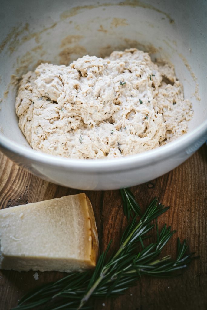 Mixing the dough to make Dutch oven artisan bread with rosemary and parmesan cheese.