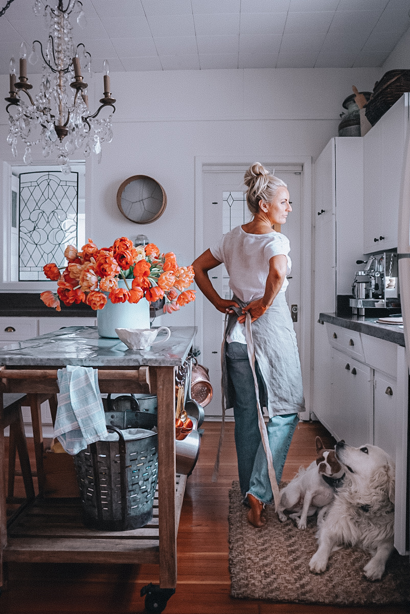 Deborah McDonald B Vintage Style tying her apron int he kitchen.