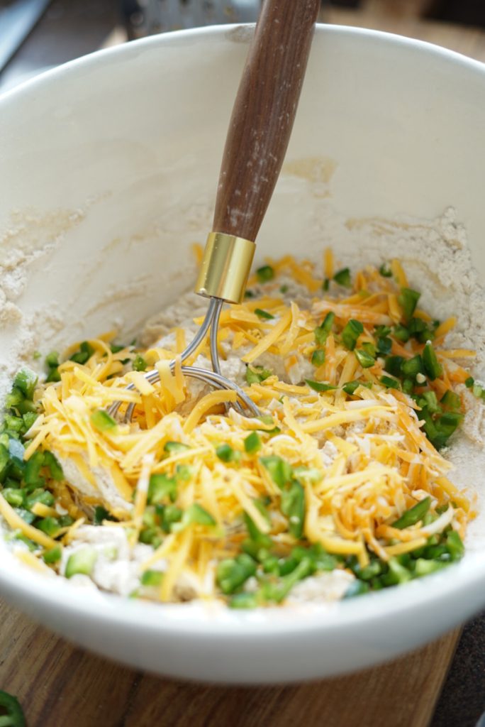 Mixing the jalapeno bread dough with cheddar cheese and jalapenos.