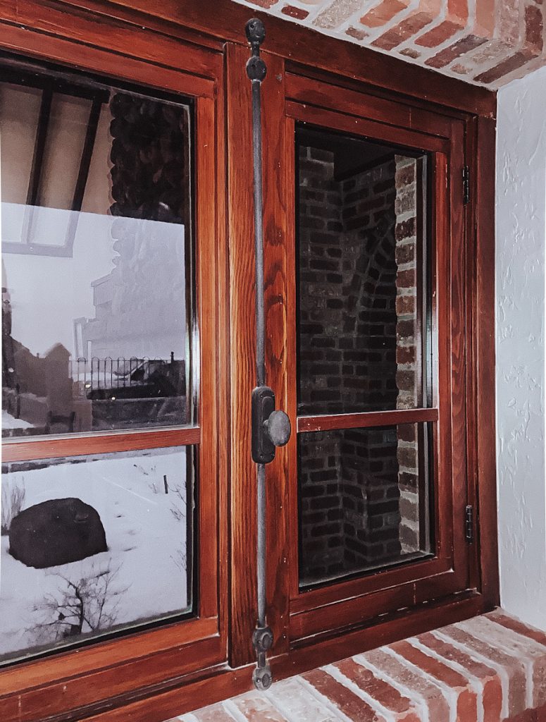A beautiful fir push and pull wooden window in a brick house.