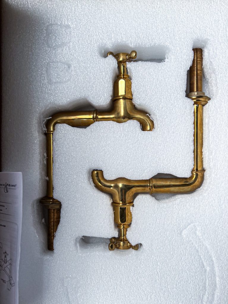 Double tap Devol faucets for a kitchen sink.